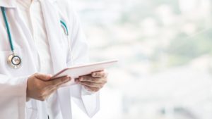 doctor holding tablet