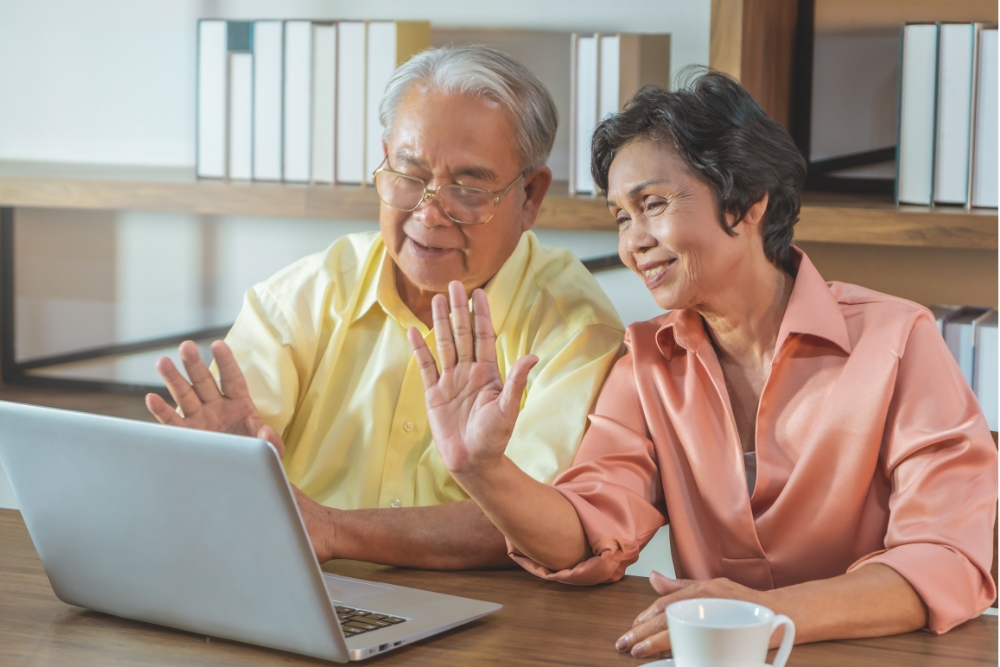 elderly asian couple using laptop computer