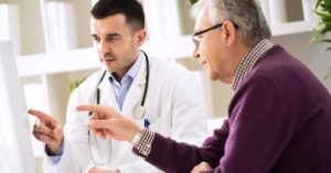 doctor and patient pointing at computer