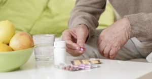 old man taking medication