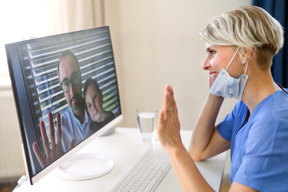 female doctor on video call with patient and child