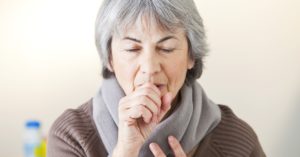 women couching into hand